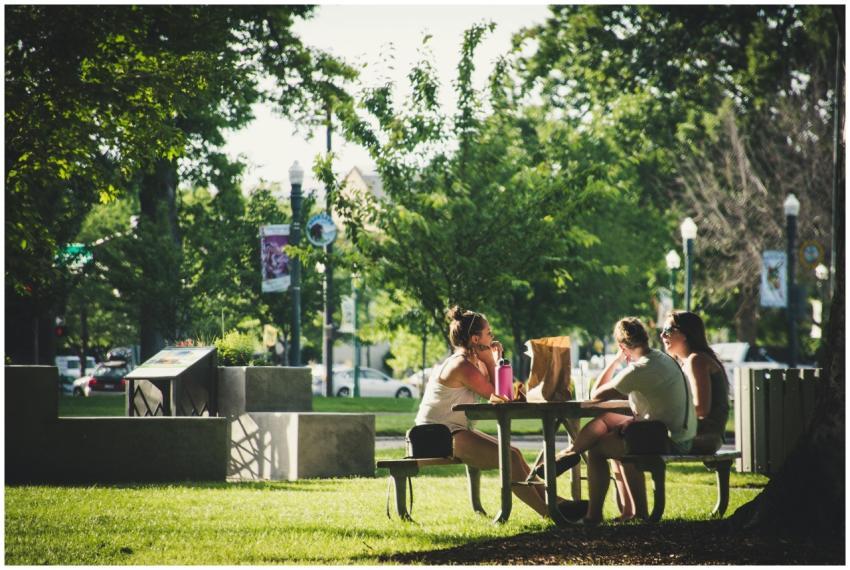 A group of friends sitting at a picnic table in a