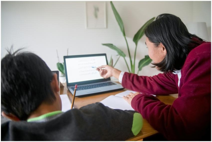 Adult guiding child in learning session using a la