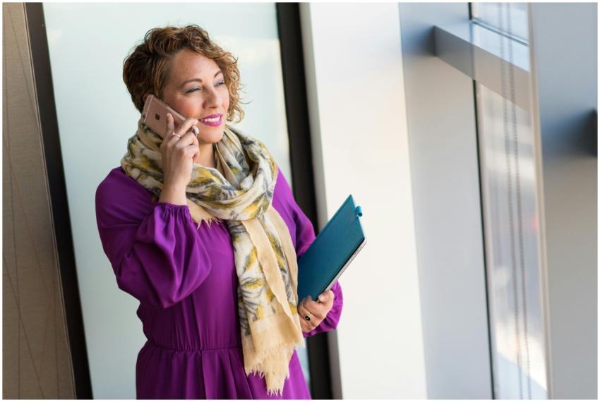 Confident woman speaking on smartphone indoors, ho
