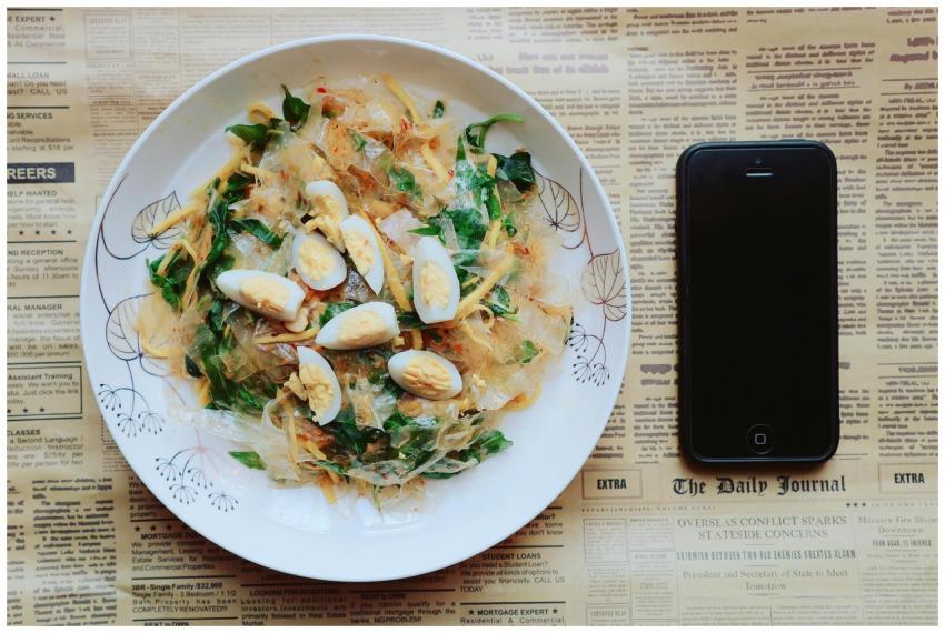 Top view of an Asian dish with boiled eggs and gre