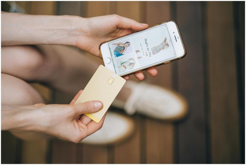 Hands holding smartphone and credit card for onlin