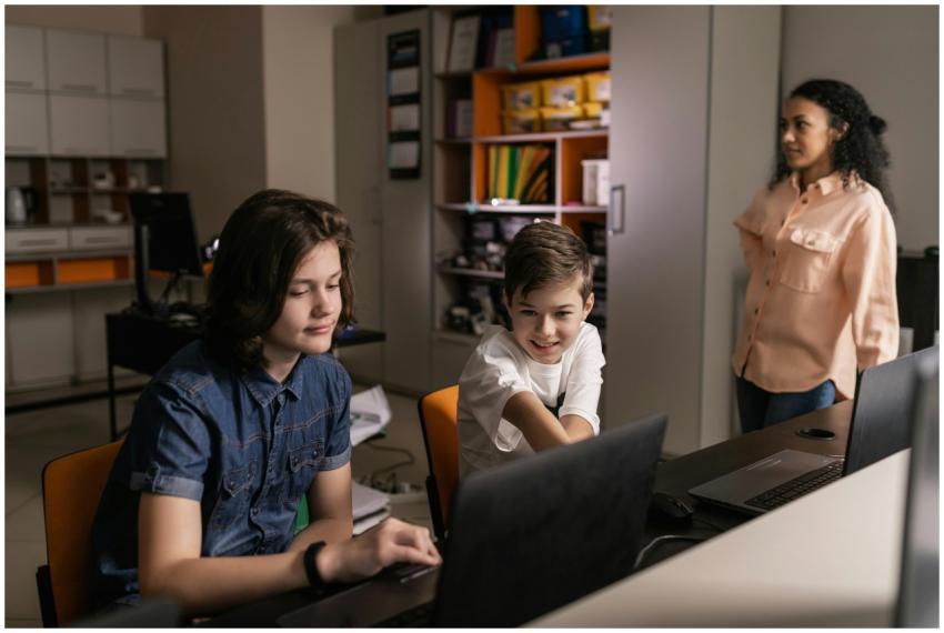 Students using laptops in a classroom setting with