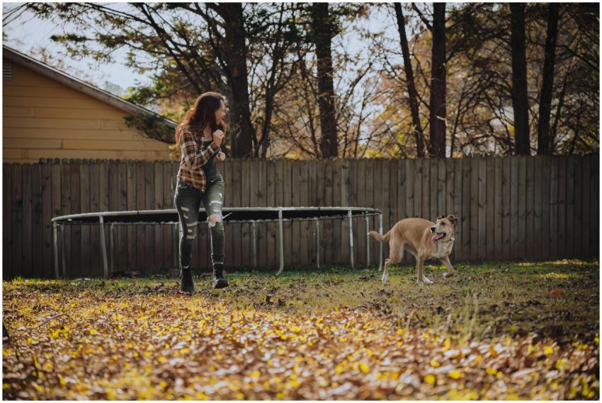 A woman enjoys a playful moment with her dog in a