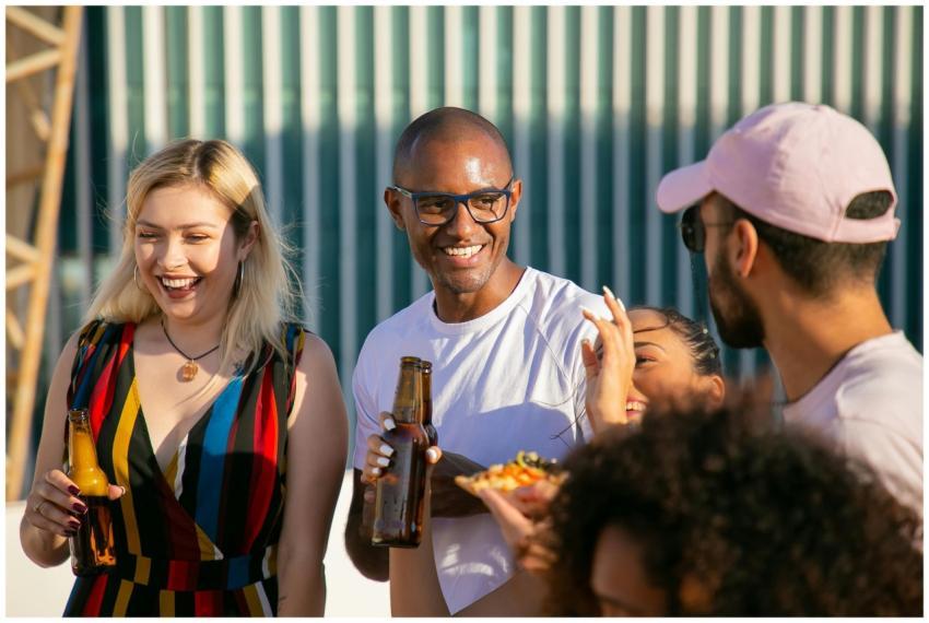 Group of delighted young multiracial friends in su