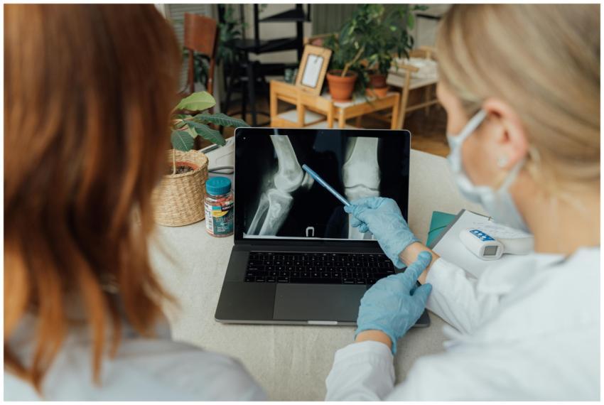 Two healthcare workers in a consultation reviewing