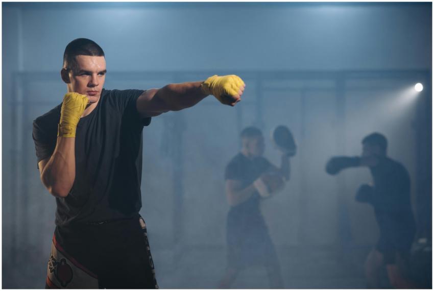 Focused fighters practicing boxing techniques with