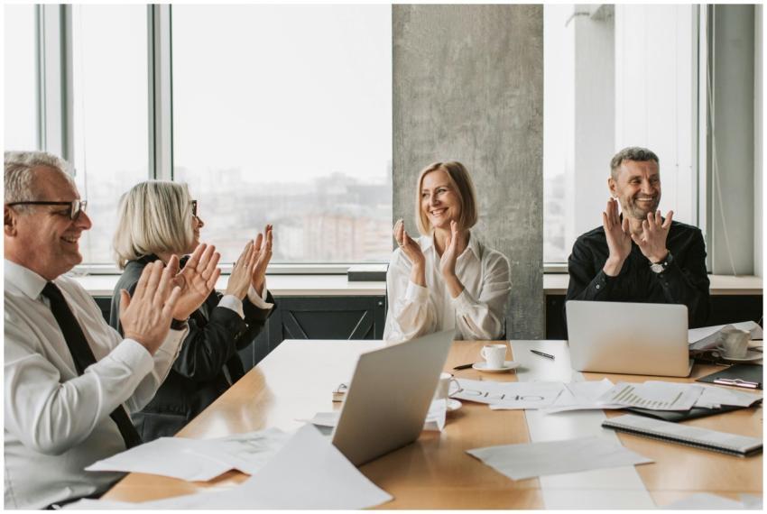 Business professionals clapping in a conference ro