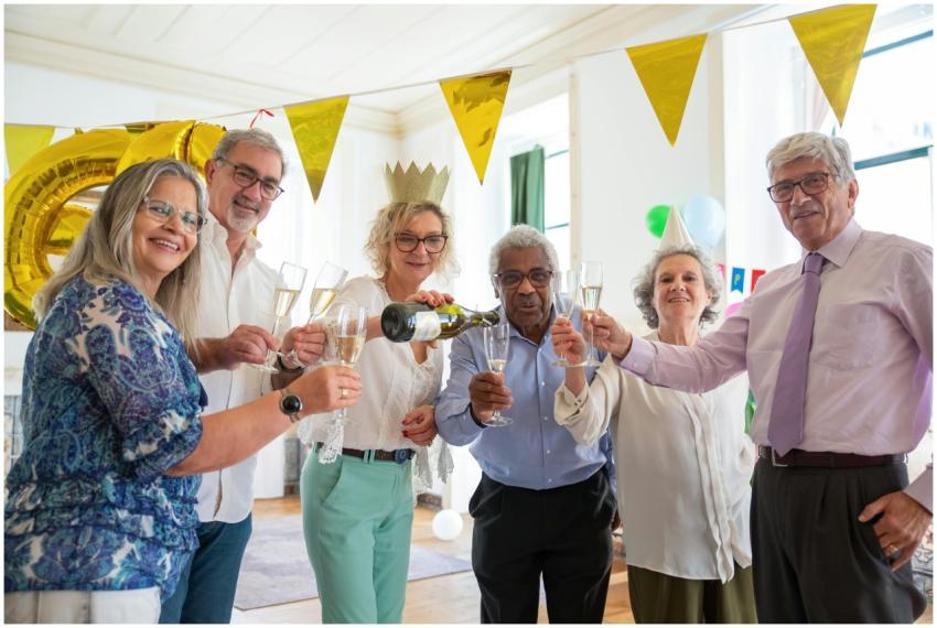 A joyful group of senior friends celebrating indoo