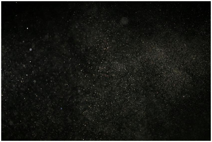 Dark textured background with floating particles,