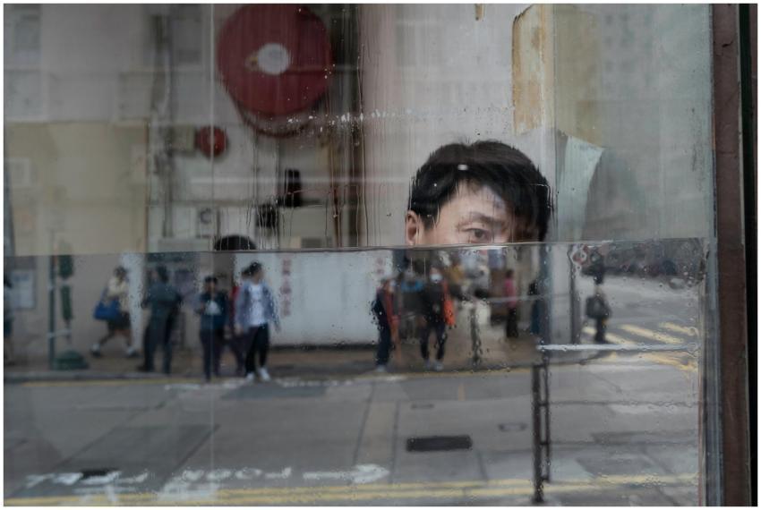 Reflections of people and an individual in a rainy