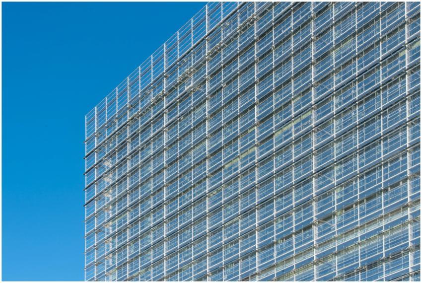 Glass facade of a modern building under clear blue