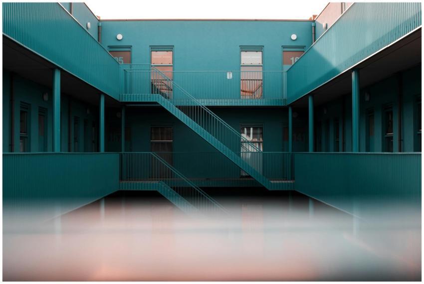 Modern interior view of a blue apartment complex f