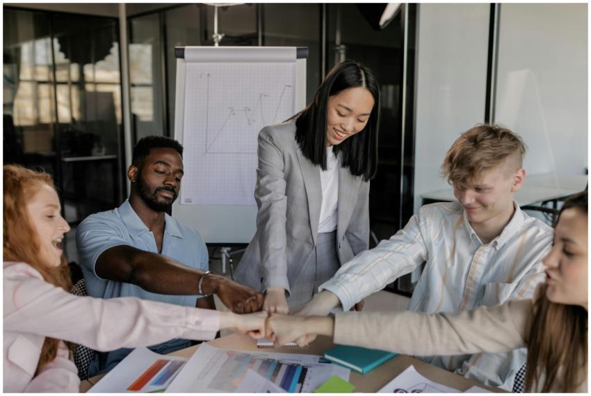 A diverse team bonding in an office meeting with c