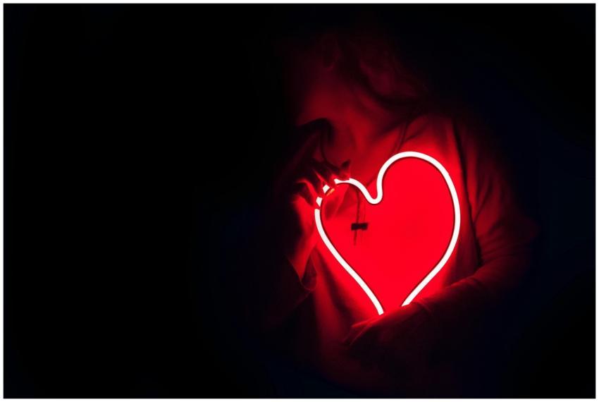 Silhouette of a person with a glowing red neon hea