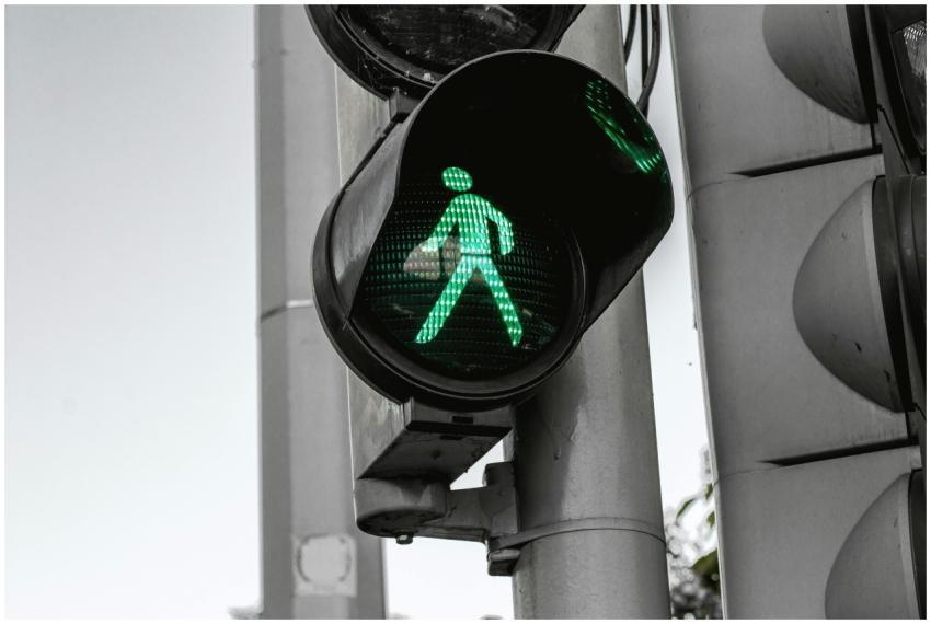 Close-up of a green pedestrian traffic signal indi