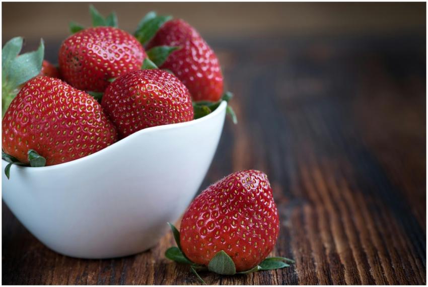 Close-up of fresh strawberries in a white bowl on