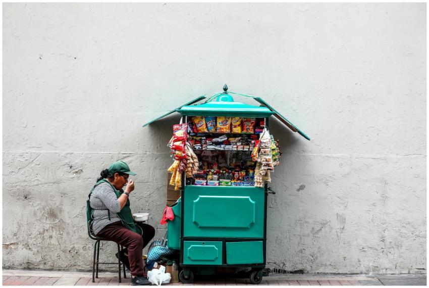 A woman enjoying a meal while sitting next to her