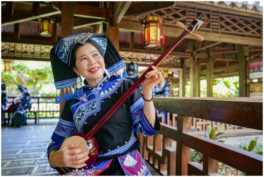 Zhuang musician in traditional ethnic attire playi
