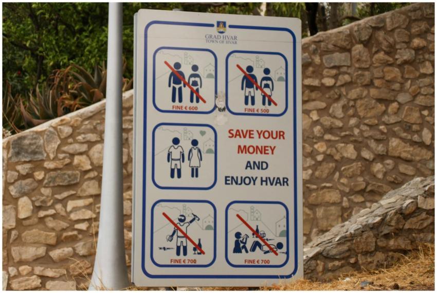 Public notice sign displaying fines for specific a