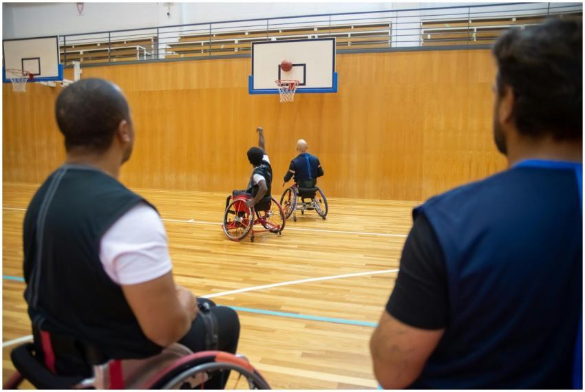 Players in wheelchairs enjoying a competitive bask