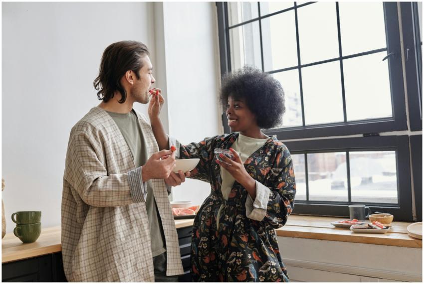 A loving couple enjoying a playful breakfast momen