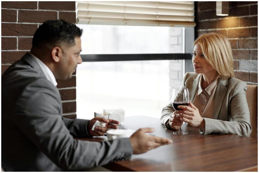 Two business professionals discussing ideas over a