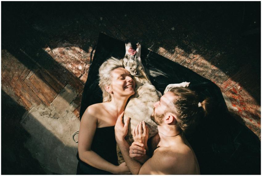 A happy couple and their dog enjoying a moment of