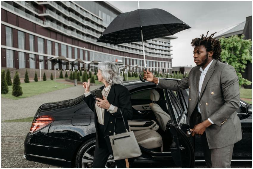 Business professionals exiting a luxury car as an