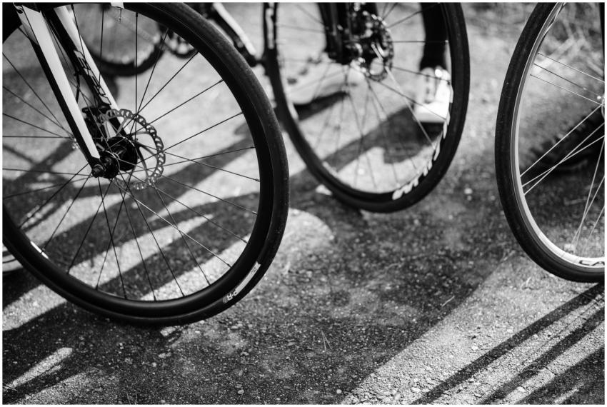 Black and white image of multiple bicycle wheels c