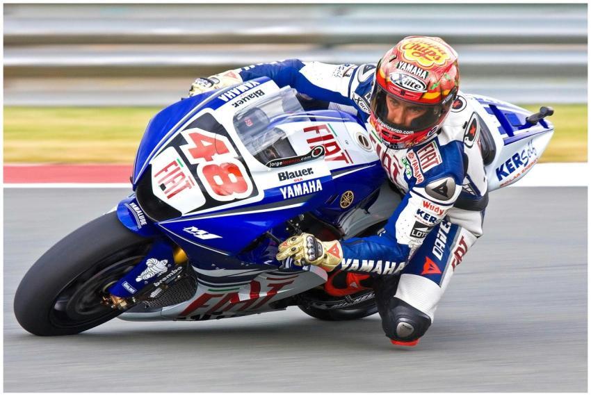 A Yamaha sports bike speeds through a race track,