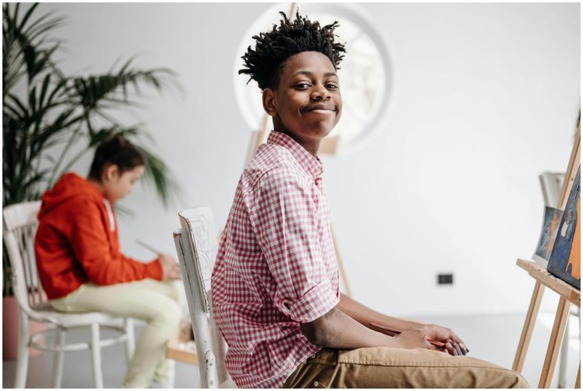 Young students enjoying a painting class, engaged