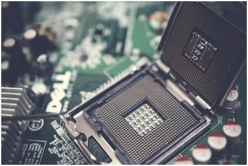 Detailed view of a CPU socket on a green motherboa