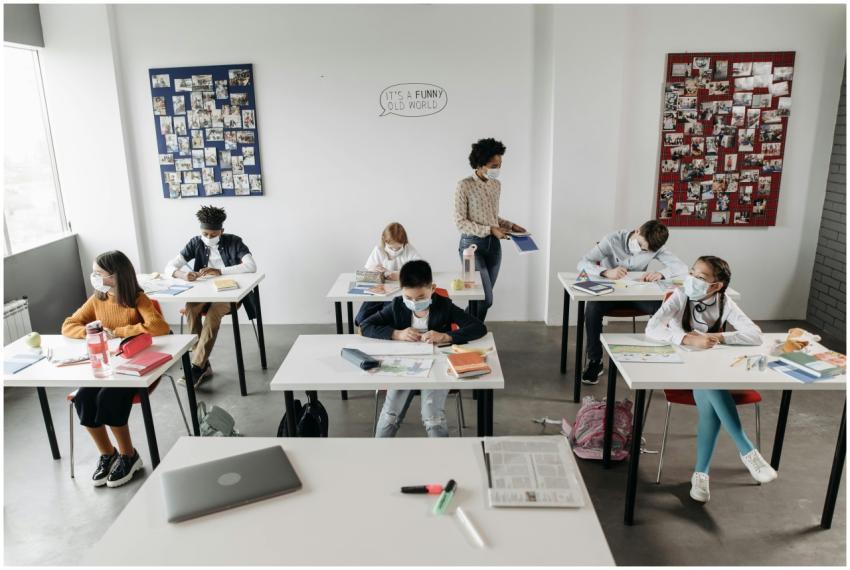 Students studying in a classroom, wearing masks fo
