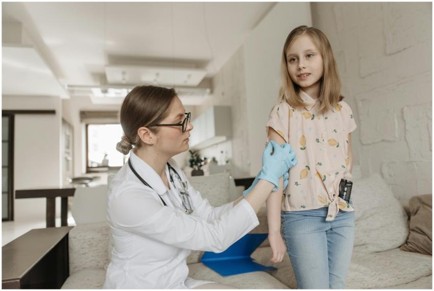 A pediatrician checks a child's arm during a home