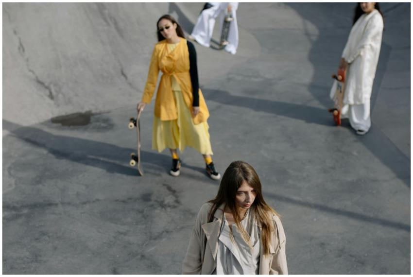 Stylish women with skateboards in an urban skatepa