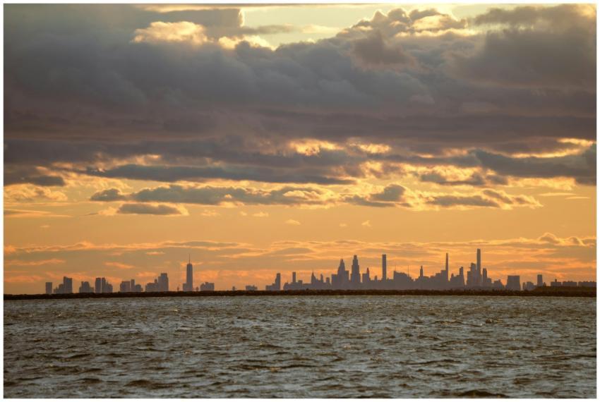 New York City skyline silhouetted against a vibran