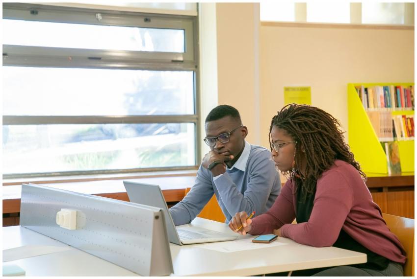 Young African American couple studying with a lapt