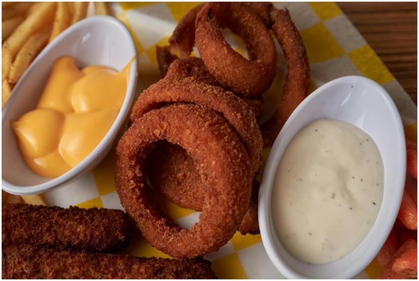 Tasty onion rings with cheese and ranch dips, perf