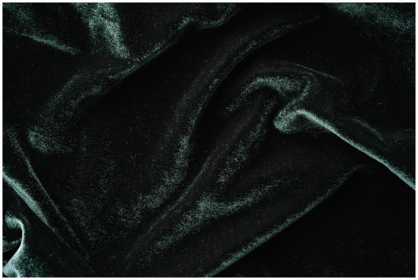 Rich textured black velvet fabric in close-up, sho