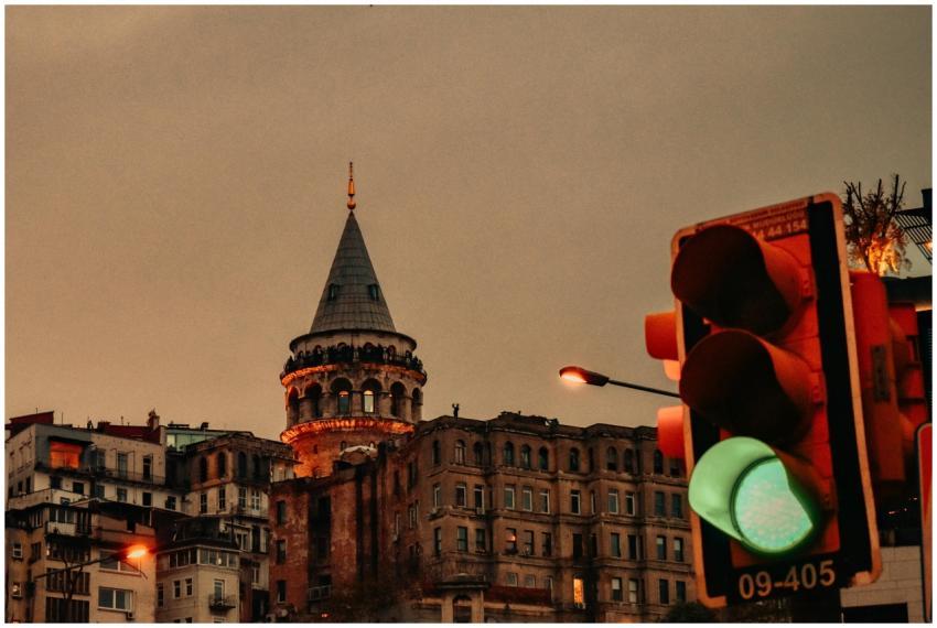 Galata Tower at dusk in Istanbul with green traffi