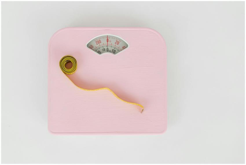 A pink weighing scale paired with a yellow measuri