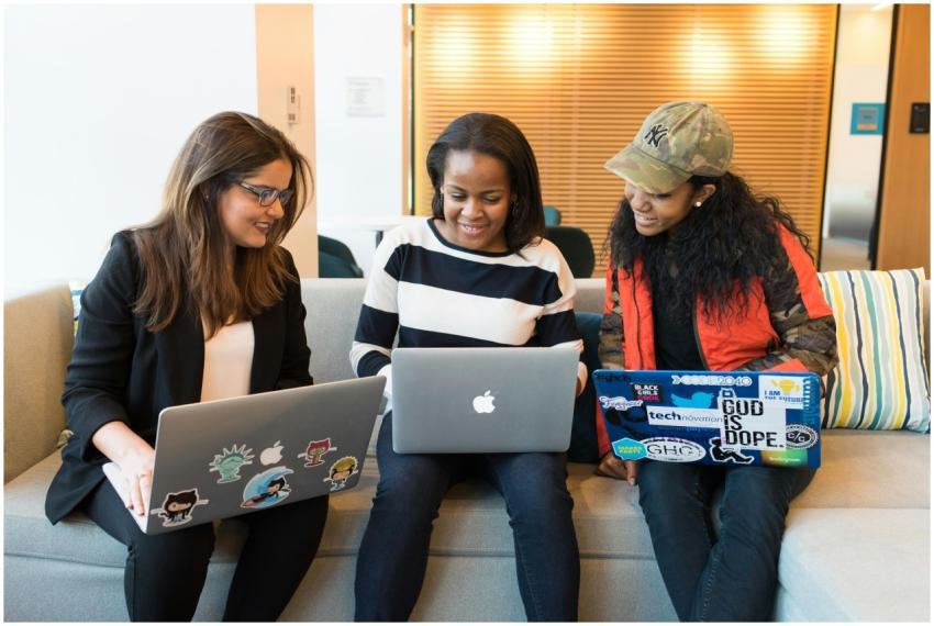 Three women working together on laptops in a casua