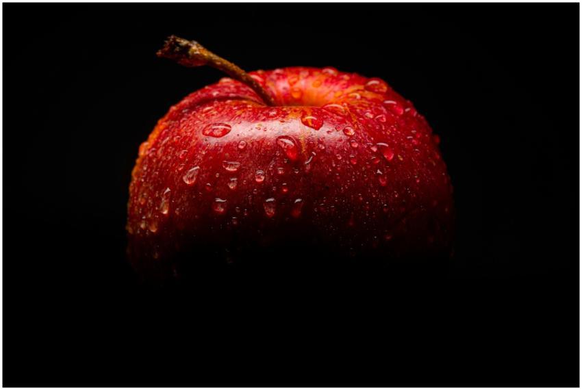 Close-up of a fresh red apple with water droplets