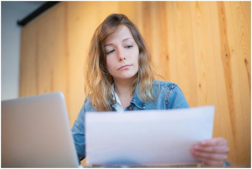 Businesswoman in a denim jacket analyzing document