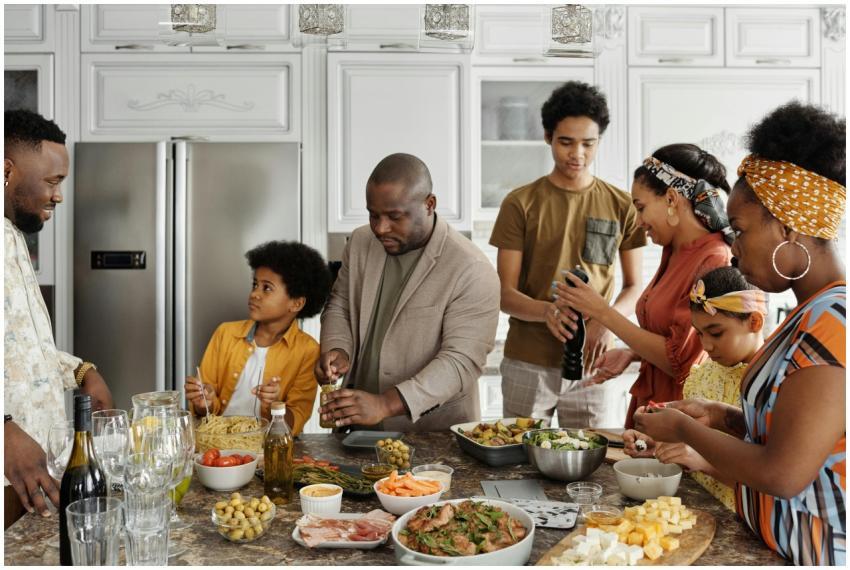 Family preparing a meal together in a lively kitch