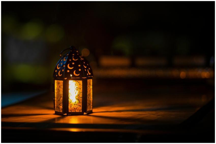 A glowing lantern with crescent motifs creates a w