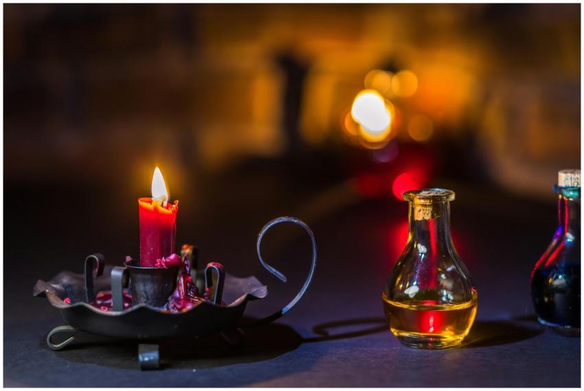 Candlelight illuminating glass bottles creates a m