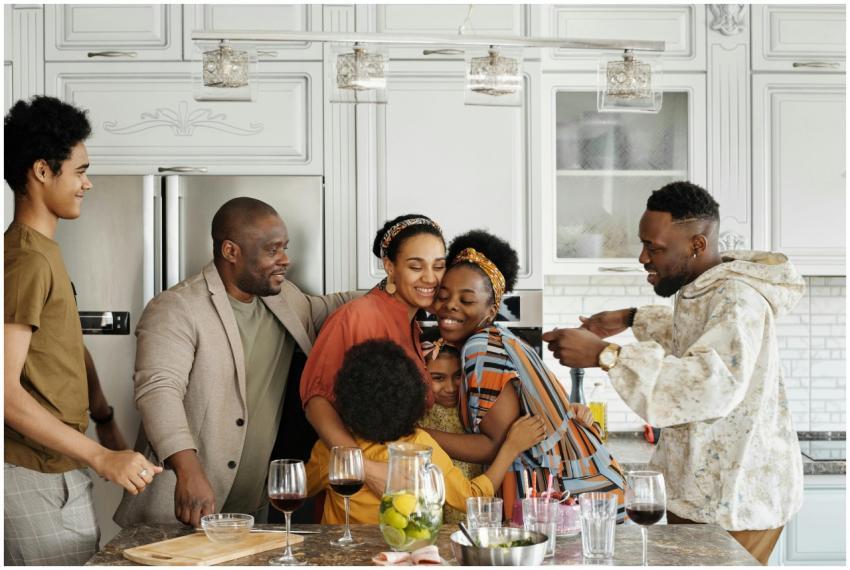 A joyful family gathering in a kitchen, embracing