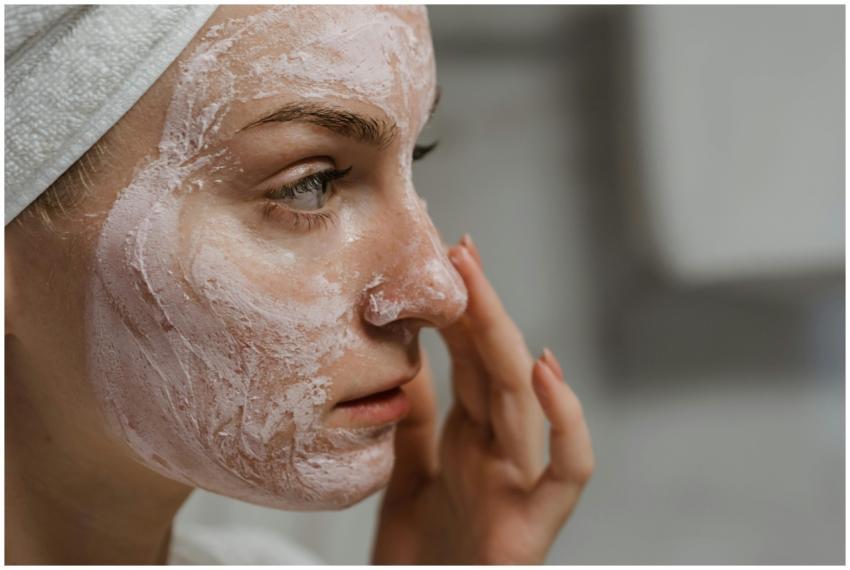 Close-up of a woman applying facial cream as part