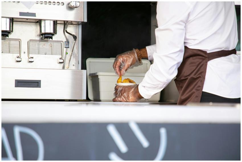 A street food vendor in uniform serving a freshly